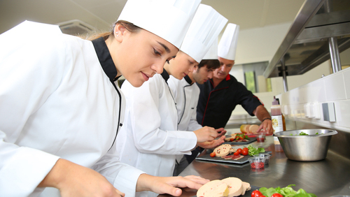 cooks learning in kitchen